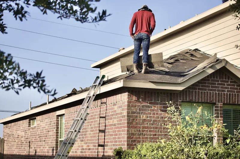 Professional roofer working on a residential roof in Chateau Village